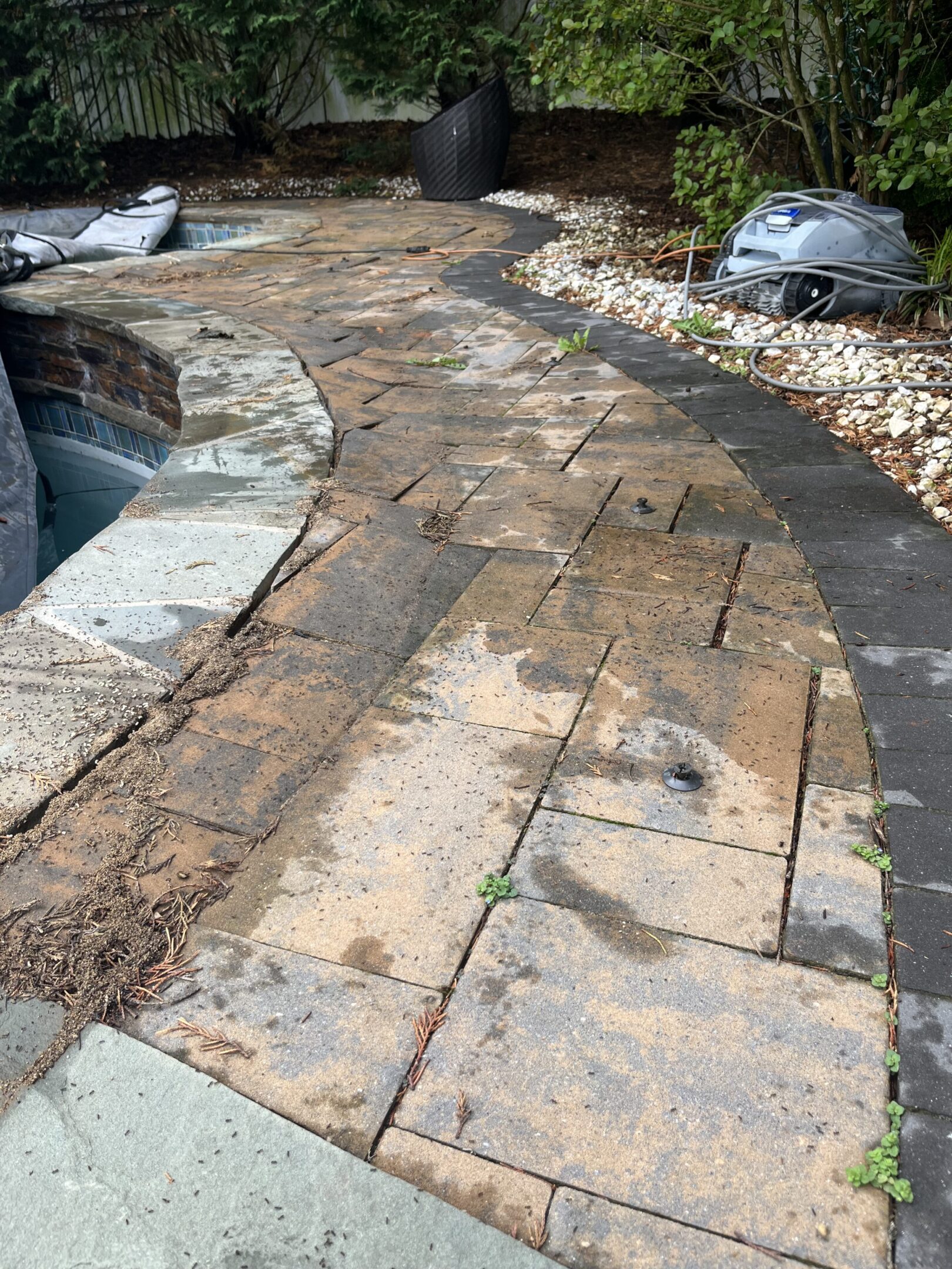 A stone pathway with dirt and debris scattered on it.
