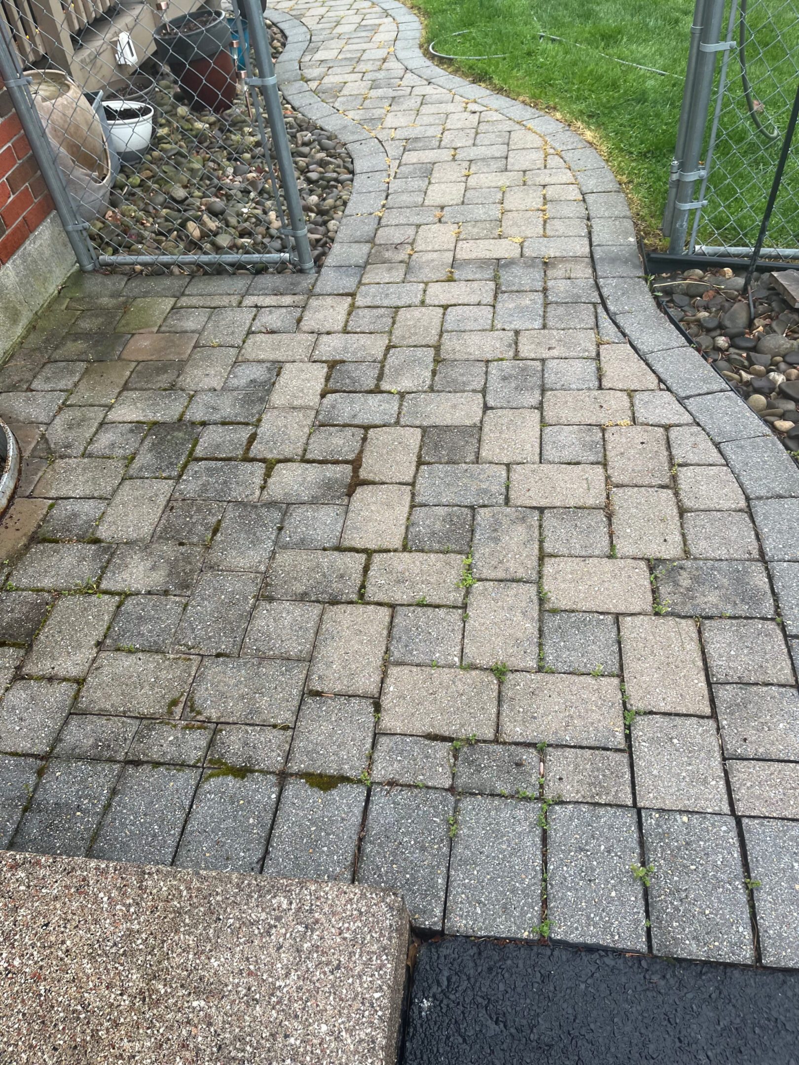 Patterned stone walkway with varying shades of gray and beige.