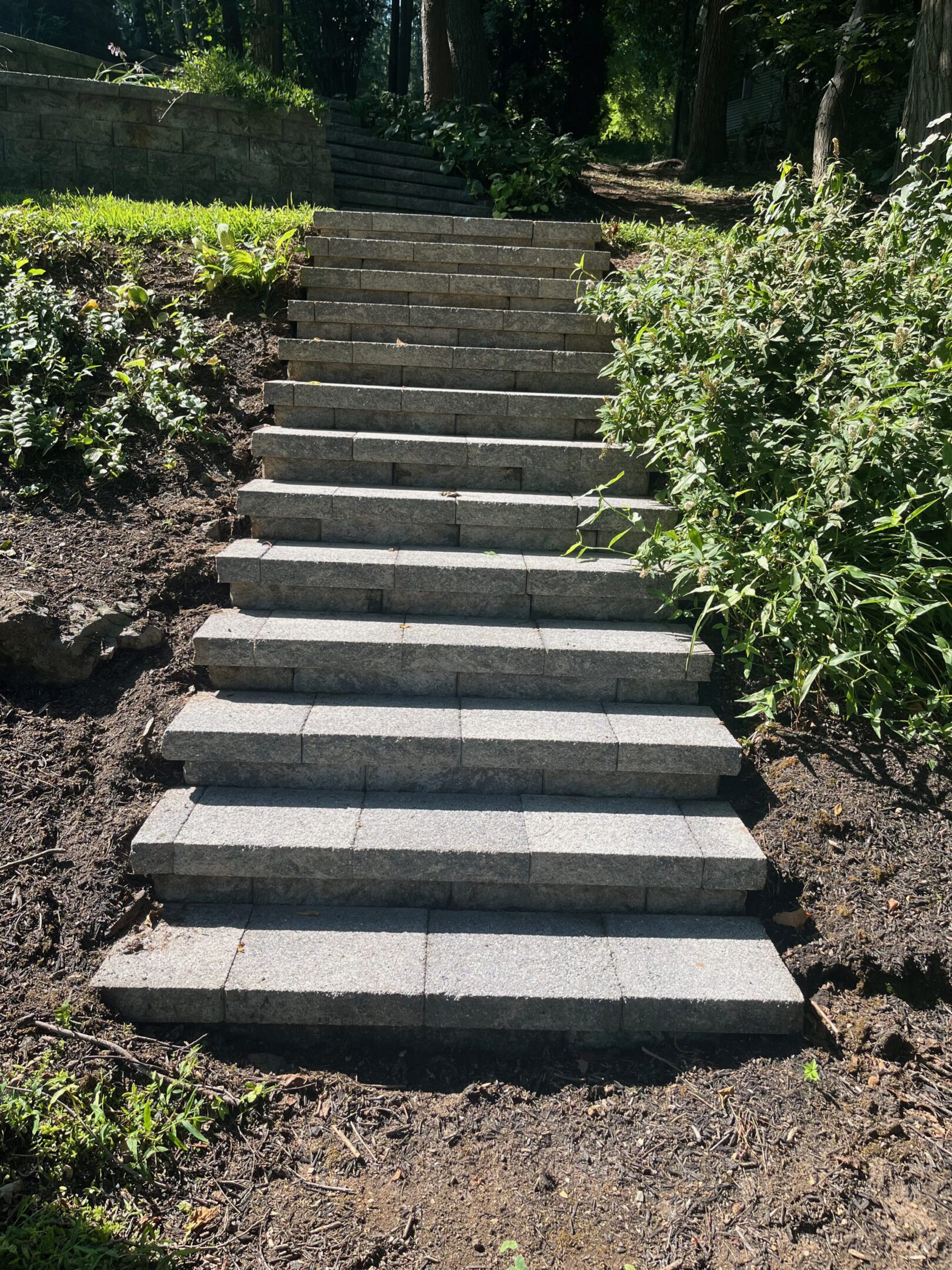 A set of newly constructed stone steps in a garden.